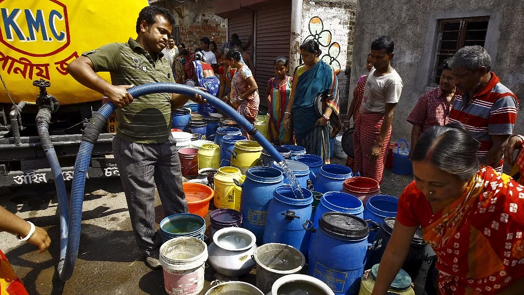 Image showing people filling drum from the water tanker, depiction of how worse Bangalore water crisis has been.