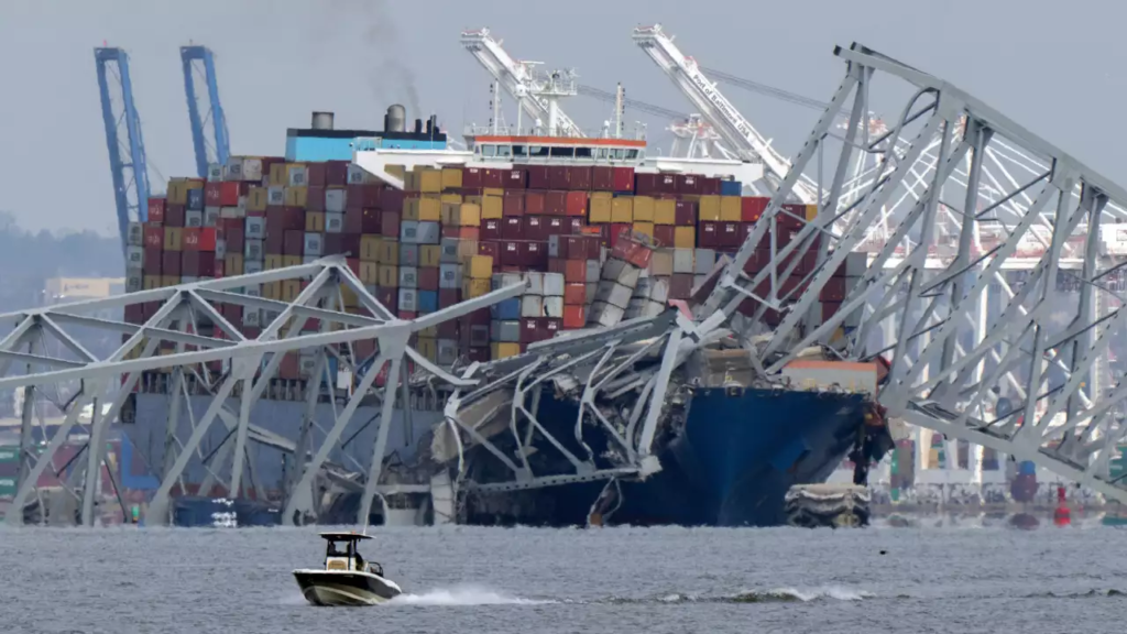 image showing cargo ship hits bridge causing it to collapse down into the river.