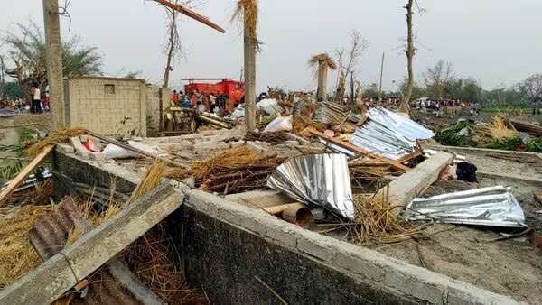 Image showing the damaged trees and huts because of the Jalpaiguri Storm.